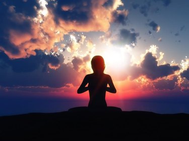 3D render of a female in a yoga pose against a sunset sky