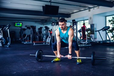 Crossfit instructor at the gym doing Deadlift exercises