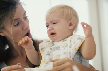 Close-up of a mother feeding her son