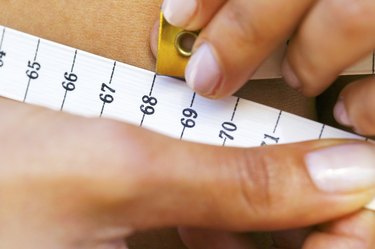 Woman measuring waistline