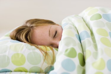 Young woman asleep in bed