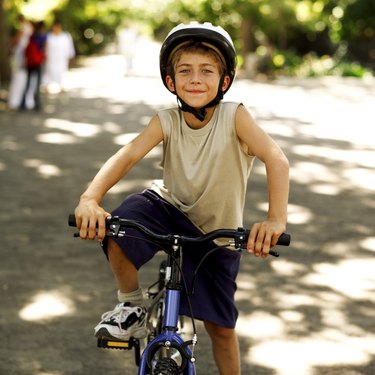 portrait of a young boy riding a bicycle