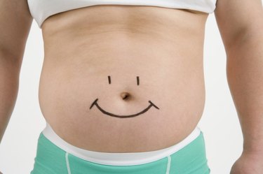 Overweight man with drawing of smiley face on stomach