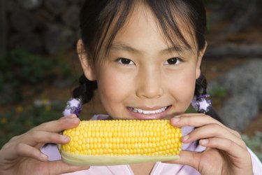 Girl holding ear of corn