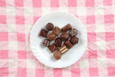 Plate of chocolates on pink tablecloth