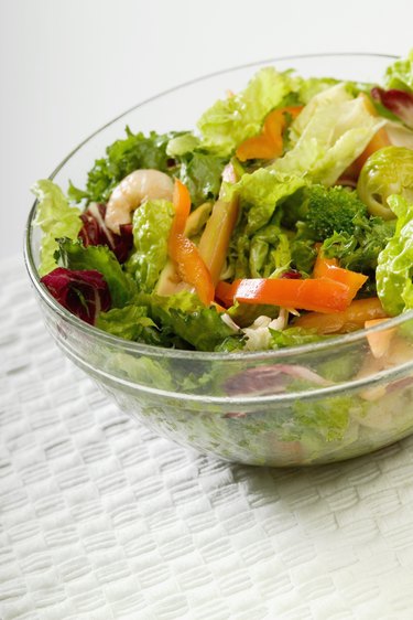 Bowl of salad with shrimp and vegetables, close-up, part of