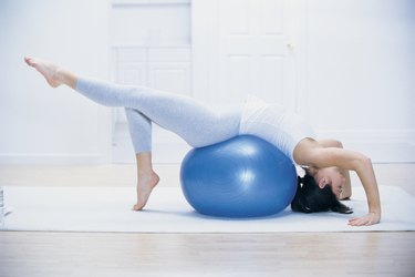 Woman stretching on yoga ball