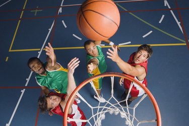 Men jumping for basketball