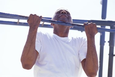 Senior man doing a chin-up