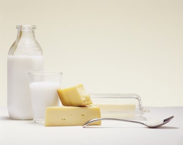 Milk Bottle, Glass of Milk, Cheese, Butter and a Spoon