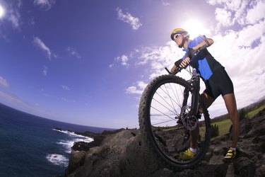 Woman with bicycle on coast