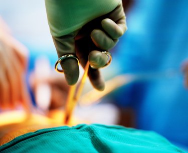 Close-up of surgeon operating with surgical scissors