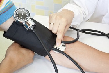 doctor measures pressure in the patient