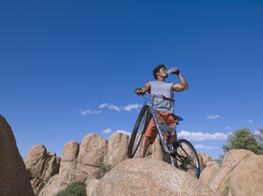 African man with mountain bike on rocks