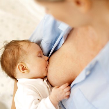 Close up of a mother breastfeeding her baby (6-12 months)