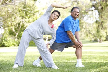 Senior Couple Exercising In Park