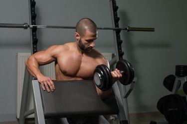 Young Man Doing Exercise For Biceps
