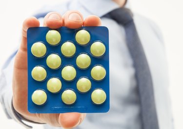 Businessman's hand holding tablets