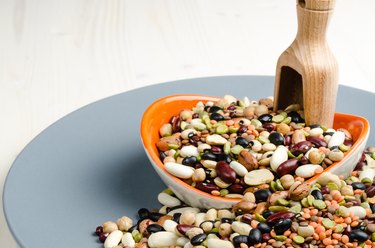 legumes in a dish on wood, close up, background