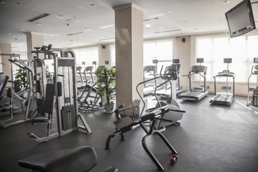 Large, bright gym with workout equipment.
