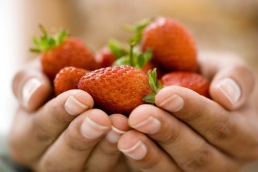 Woman holding strawberries