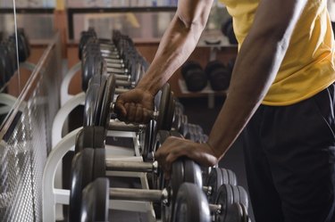 Man taking weights from rack