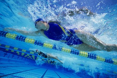 Swimmers Racing in Pool