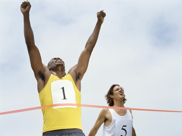 low angle view of male athlete crossing the finish line