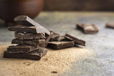 pieces of dark chocolate with caffeine stacked on a gray table