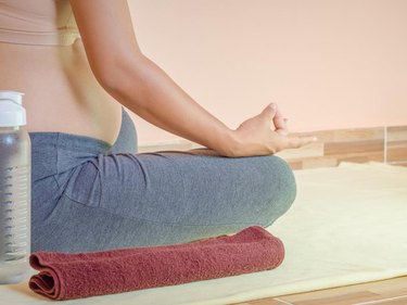 Pregnant woman doing yoga. healthy motherhood concept.