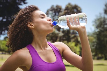 Fit woman taking a drink