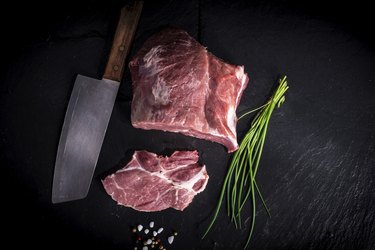 Pork shoulder with butcher knife