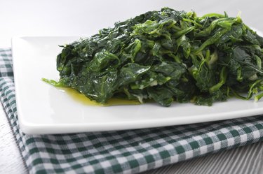 Boiled spinach on white dish.