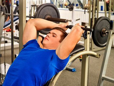 Man working his arms and chest at gym