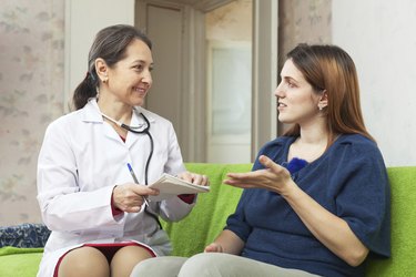 Woman complaining to mature doctor