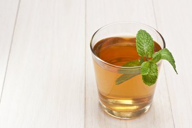 Cup of hot tea with fresh mint leaves