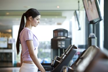 A young woman walking on the treadmill