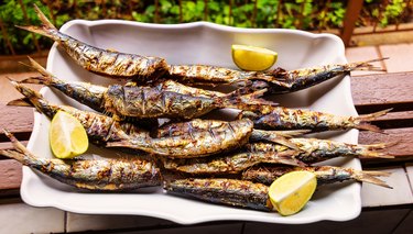 Barbequed Sardines on white plate.