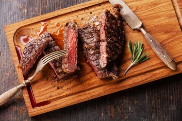 Sliced medium rare grilled steak Ribeye with rosemary