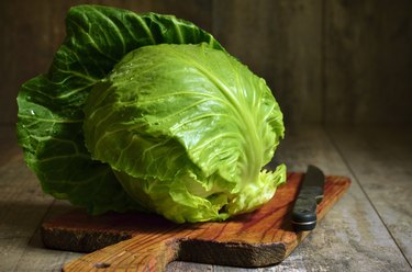 Cabbage head on cutting board.