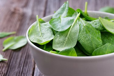 Fresh young leaves of spinach in bowl