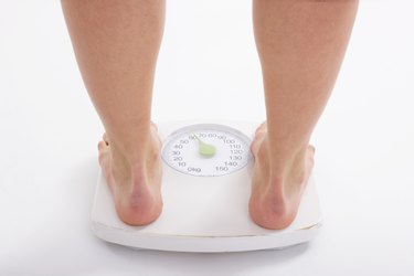 Woman standing on weight scale