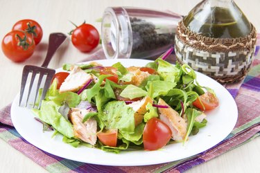 Delicious fresh salad with salmon, lettuce, cherry tomatoes