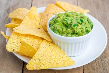 Cup with chunky guacamole served with nachos