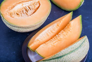Cantaloupe melon slices on blue background, not blueberries and Barrett’s esophagus