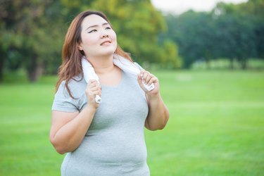 Happy fatty fit woman posing outdoor