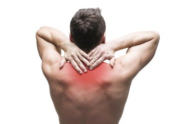 Pain in the neck. Man with backache. Muscular male body. Isolated on white background with red dot