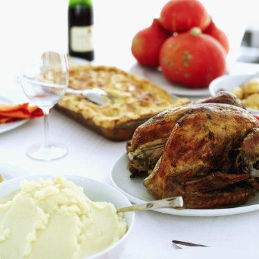 Close-up of mashed potatoes served with roast chicken on a table