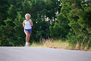Woman jogging on side of road