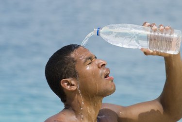 Hispanic man pouring water over head